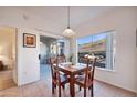 Bright dining area featuring a wooden table, view of mountains, and access to a patio at 3236 E Chandler Blvd # 1076, Phoenix, AZ 85048