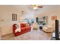Bright living room with large window, ceiling fan, comfortable seating, and open to the dining area at 3236 E Chandler Blvd # 1076, Phoenix, AZ 85048