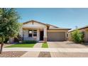 Beautiful home with a well-manicured lawn, desert landscaping, and a covered front porch at 3877 E Oxford Ln, Gilbert, AZ 85295