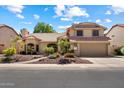 Charming two-story home featuring a well-manicured front yard and a spacious two-car garage at 401 N Cholla St, Chandler, AZ 85224