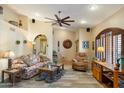 Bright living room featuring a ceiling fan, and an arched entryway at 401 N Cholla St, Chandler, AZ 85224