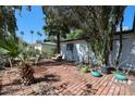 A brick patio offers a relaxing outdoor space, complemented by desert landscaping and mature trees at 4142 N 35Th St, Phoenix, AZ 85018