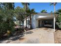 Exterior view of a charming home featuring a carport and lush greenery, exuding a welcoming curb appeal at 4142 N 35Th St, Phoenix, AZ 85018