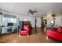 Spacious living room with unique vintage decor, including a vintage piano and ceiling fan, for comfortable living at 4142 N 35Th St, Phoenix, AZ 85018