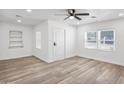 Inviting bedroom with wood-look floors, a ceiling fan, and ample natural light at 432 W 1St St, Mesa, AZ 85201