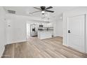 Bright, open living space with modern ceiling fan and seamless flow into kitchen at 432 W 1St St, Mesa, AZ 85201