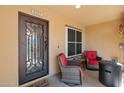 Cozy porch with seating area and decorative iron door, perfect for relaxing outdoors at 4347 N 24Th Way, Phoenix, AZ 85016