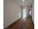 Hallway features tile flooring, white walls and doors, and recessed lighting at 47692 W Moeller Rd, Maricopa, AZ 85139