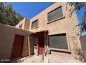 Two story townhome with red door and window coverings at 5002 N 41St Ave, Phoenix, AZ 85019