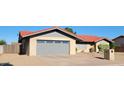 Single Gathering home featuring a two car garage with a brick exterior and desert landscaping at 650 N 65Th Way, Mesa, AZ 85205
