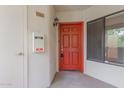 Entrance featuring a red door with a mail slot and a security light above the unit number at 750 E Northern E Ave # 2145, Phoenix, AZ 85020