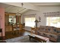 Cozy living area with a dining room, wood floors, and a Southwest-style sofa at 8310 E Deep Canyon Ct, Mesa, AZ 85208