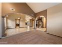 Spacious living area featuring travertine flooring, decorative columns, and a staircase to the upper level at 1001 N Peppertree Dr, Gilbert, AZ 85234