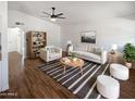 Bright and airy living room featuring stylish furniture, a ceiling fan, and wood-look flooring at 1019 N 62Nd Ave, Phoenix, AZ 85043