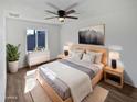 Serene main bedroom with a ceiling fan, natural light, and contemporary furnishings at 1019 N 62Nd Ave, Phoenix, AZ 85043