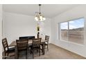 Bright dining room with a wood table set and a window view at 10539 W Tamara Dr, Casa Grande, AZ 85193