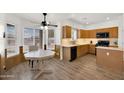Charming kitchen with a breakfast nook, wood cabinets, and natural light at 10539 W Tamara Dr, Casa Grande, AZ 85193