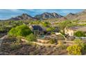 Stunning aerial view of the home with a pool, desert landscaping, and scenic mountain backdrop at 10875 E Mirasol Cir, Scottsdale, AZ 85255