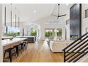 Bright living room with hardwood floors, soaring ceilings, and modern fireplace open to the kitchen at 10875 E Mirasol Cir, Scottsdale, AZ 85255
