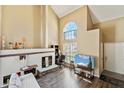 Bright, airy living room boasts vaulted ceilings, a stone fireplace, and large window at 1126 W Elliot Rd # 1066, Chandler, AZ 85224