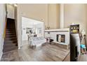 Open-concept living room with fireplace, stairs, and dining area offers ample natural light at 1126 W Elliot Rd # 1066, Chandler, AZ 85224