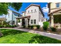 Charming two-story home features a covered porch, landscaped front yard, and well-maintained lawn, creating inviting curb appeal at 1324 S Banning St, Gilbert, AZ 85296