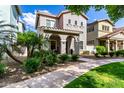 Charming two-story home features a covered porch, landscaped front yard, and well-maintained lawn, creating inviting curb appeal at 1324 S Banning St, Gilbert, AZ 85296