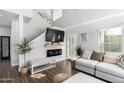 Bright living room with high ceilings, a modern fireplace, and stylish furnishings that create a comfortable and inviting space at 1324 S Banning St, Gilbert, AZ 85296