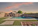 A refreshing pool area with a tanning ledge and a peaceful backyard at 13625 W Peck Ct, Litchfield Park, AZ 85340