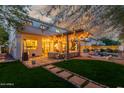 Expansive backyard with a covered patio, lounge seating, and lush greenery, ideal for relaxation and enjoyment at 1421 W Saltsage Dr, Phoenix, AZ 85045