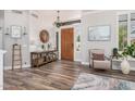 Stylish foyer showcasing hardwood floors, a decorative chandelier, and a charming entryway table at 1421 W Saltsage Dr, Phoenix, AZ 85045