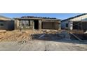 New home exterior showing stucco, roof tile installation, and an attached two-car garage at 15781 W Beryl Ave, Waddell, AZ 85355