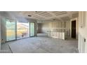 Spacious living room featuring drywall, sliding glass doors, and abundant natural light at 15781 W Beryl Ave, Waddell, AZ 85355