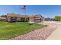 A single-Gathering home boasts a well-manicured front lawn and an attached two-car garage at 2003 W Tyson St, Chandler, AZ 85224