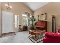 Cozy living room with vaulted ceiling, ample natural light, and a piano, creating a welcoming atmosphere at 22022 W Moonlight Path, Buckeye, AZ 85326