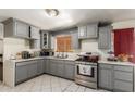 Updated kitchen featuring stainless steel appliances and gray cabinetry at 2207 N 53Rd Ave, Phoenix, AZ 85035