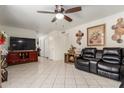 Bright living room featuring tile flooring and a plush leather sofa at 2207 N 53Rd Ave, Phoenix, AZ 85035