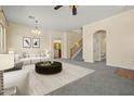 Spacious living room boasts neutral tones, carpet, and seamless flow; ideal for gatherings and relaxation at 2592 E San Rafael Trl, Casa Grande, AZ 85194