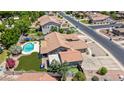 An aerial view of the home with a sparkling pool and manicured backyard with artificial turf at 3060 E Hope St, Mesa, AZ 85213