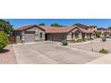 Wide driveway and two-car garage of this beautiful home with desert landscaping at 3060 E Hope St, Mesa, AZ 85213