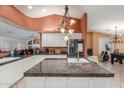 Spacious kitchen featuring granite countertops, a central island, and modern appliances at 3060 E Hope St, Mesa, AZ 85213