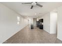 Spacious living area with tile flooring, recessed lighting, and an open layout adjacent to the kitchen at 35266 W San Sisto Ave, Maricopa, AZ 85138
