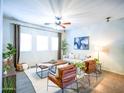 Bright living room featuring stylish furniture, a ceiling fan, and neutral decor at 35721 N Zachary Rd, Queen Creek, AZ 85144