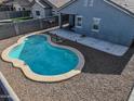 Backyard view with a refreshing blue swimming pool, desert landscaping, and an open patio at 35721 N Zachary Rd, Queen Creek, AZ 85144