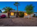 Inviting single-story home with desert landscaping, mature palm trees and cozy front porch at 3624 E Hearn Rd, Phoenix, AZ 85032
