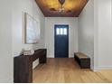 Inviting foyer with wood floors, a stylish console table, and a striking wood-paneled ceiling at 4107 E Edgemont Ave, Phoenix, AZ 85008