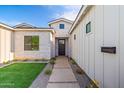 Inviting home entrance featuring a modern stone walkway, lush lawn and meticulous landscaping at 4107 E Edgemont Ave, Phoenix, AZ 85008