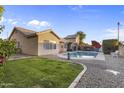 Lovely backyard with lush green grass, a sparkling pool, and manicured landscaping at 418 W Sagebrush St, Gilbert, AZ 85233