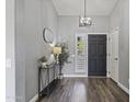 Inviting foyer with wood floors, stylish console table, mirror, and modern light fixture at 418 W Sagebrush St, Gilbert, AZ 85233