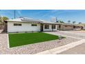 Attractive single-Gathering home with a green lawn, solar panels, and a welcoming walkway at 4531 N 12Th Dr, Phoenix, AZ 85013